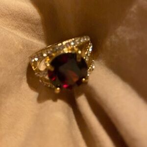 Gold tone ruby color stone with gold tone ring